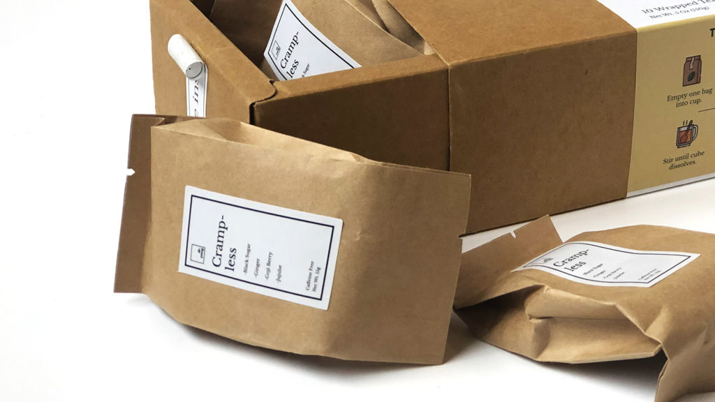 Beautifully packaged coffee in brown paper with a minimalist label for branding.
